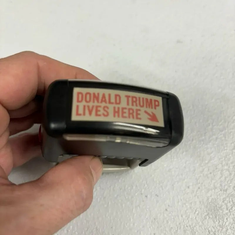 Donald Trump Lives Here Stamp - Black Design with Red Text, Ideal for Collecting and Displaying T-Shirts, Hoodie, Sweatshirt