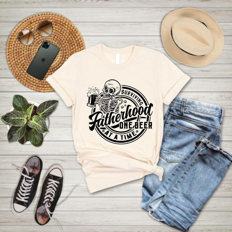 Fatherhood Shirt, Surviving Fatherhood One Beer At A Time, Funny Father Tee, Drinking Husband, Fathers Day Gift, Gift For Dad,Skeleton Dad