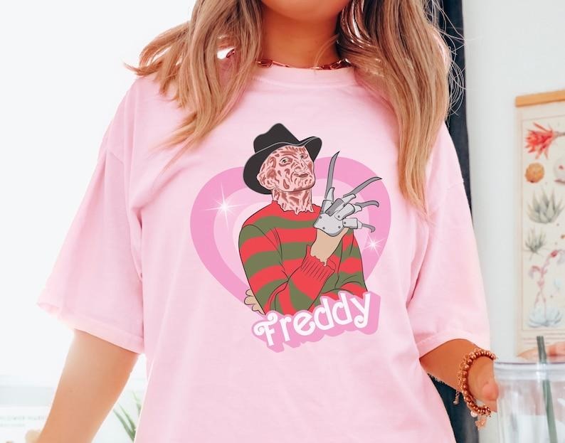 Freddy doll tshirt, horror movie doll tshirt, funny Halloween graphic tee, pink spooky shirt, retro aesthetic, scary characters Valentines