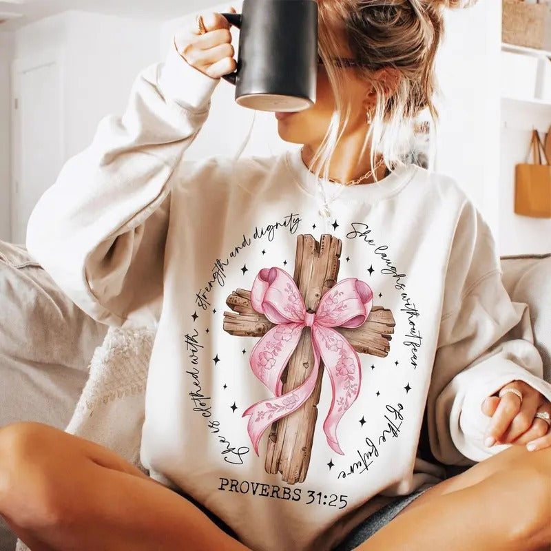She is Clothed with Strength and Dignity Jesus Faith Sweatshirt, She Is Bible Verse Pink Bow Cross Sweatshirt, Christmas...