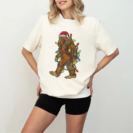 Festive Christmas Bigfoot Unisex t-shirt, Funny Santa Bigfoot Christmas Shirt, T-Shirt in all sizes and all colors for men and women