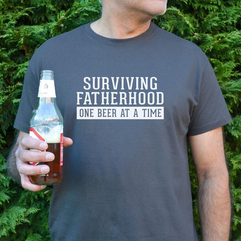 Surviving Fatherhood Men's t shirt, dad t shirt, Father's day gift, Father's day t shirt, Dad Beer t-shirt Hoodie, Sweatshirt
