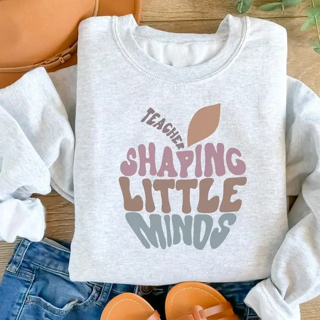 Teaching Sweatshirt, Teaching Shaping Little Minds Shirt, Teacher Sweatshirt, New Teacher Gift, Elementary Teacher Sweater Fit Jersey Casual Classic Cotton Knit