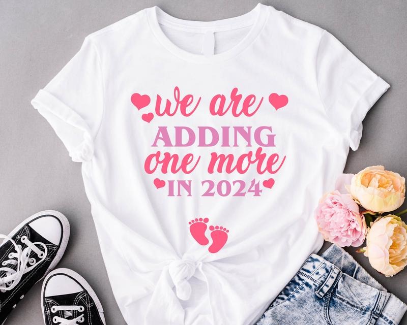 Valentine Pregnancy Announcement Shirt, We're adding one More in 2024 T-Shirt, Pregnancy Reveal Tee, New Mother Gift...