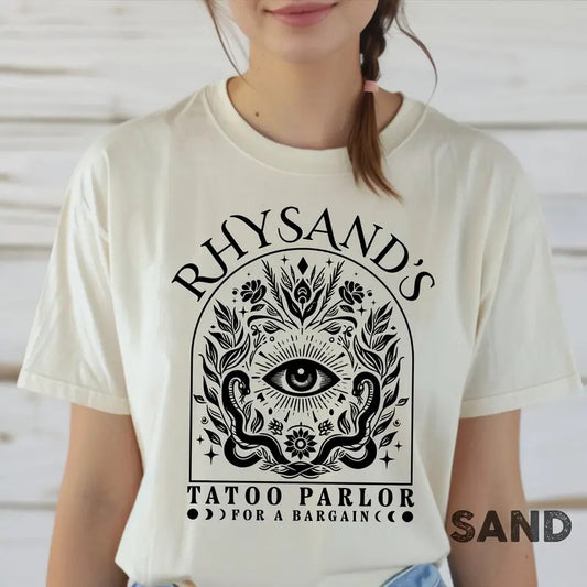 is a mAcotar Velaris Rhysand's Tattoo Parlor T-shirt featuring Feyre and Rhysandust-have for fans of the novel series....